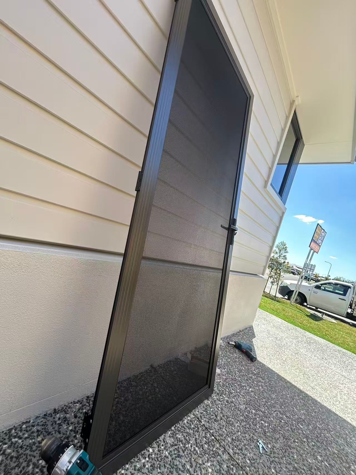 Hinged security screen door installation